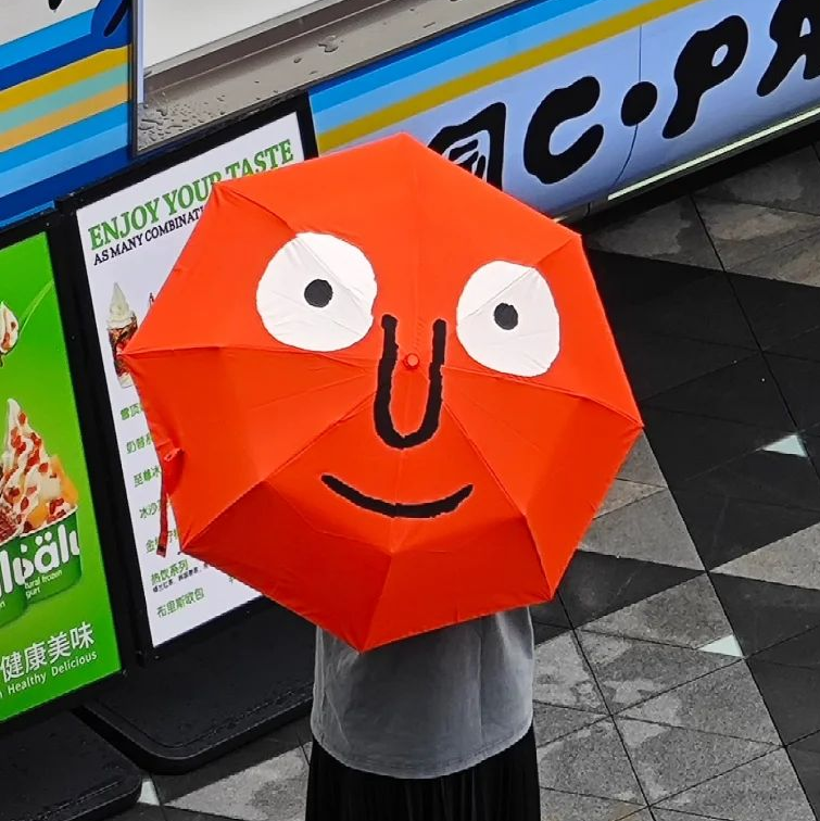 Quirky Cartoon Face Umbrella - Vibrant Orange Novelty Rain Gear